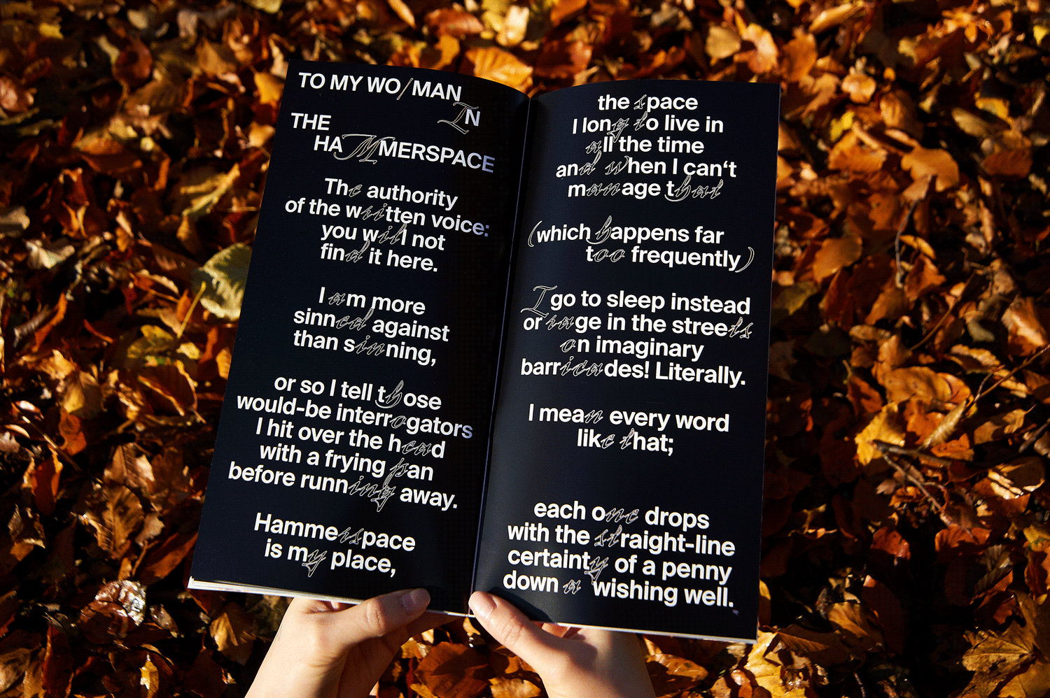 Opened book with black background and white type on it